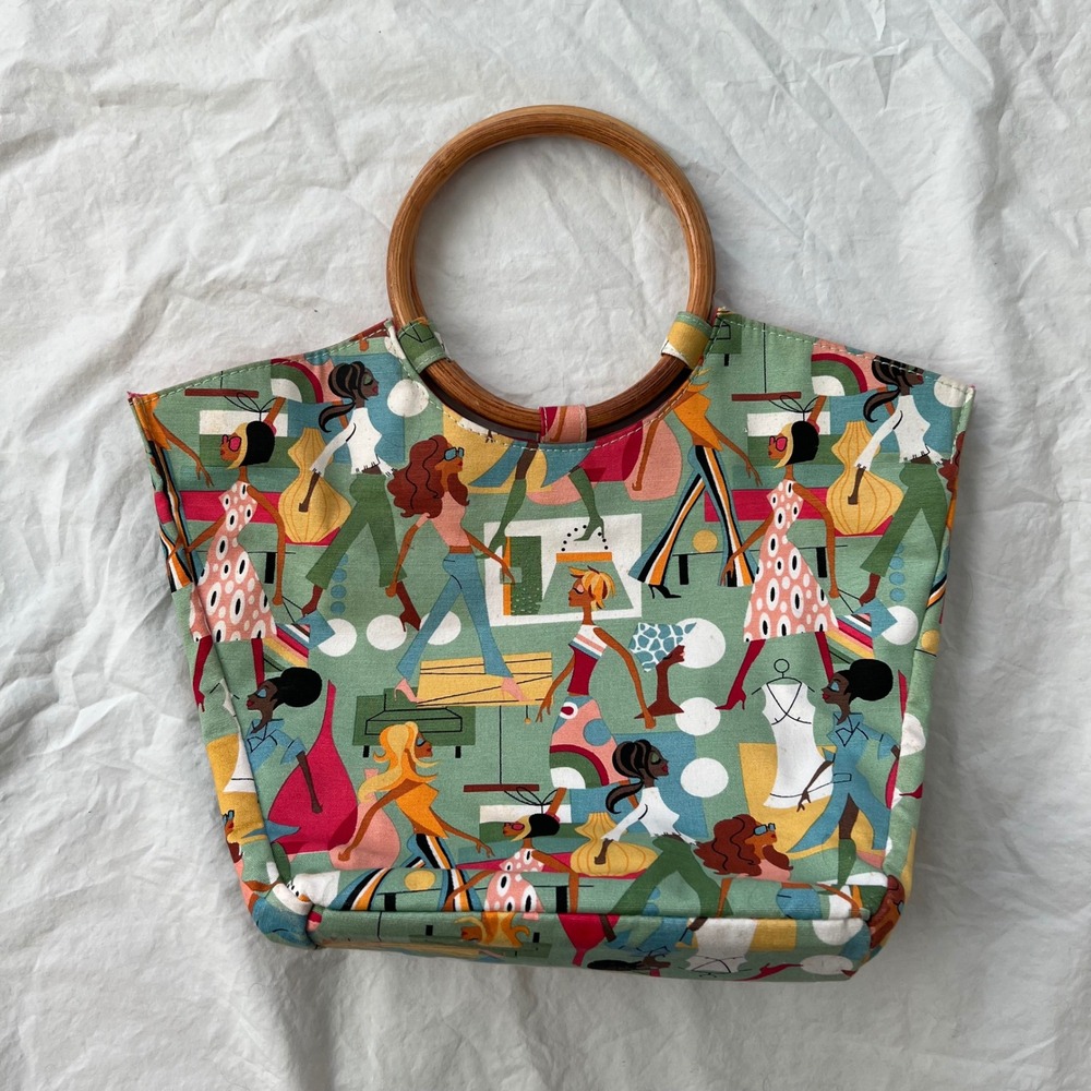 vintage neiman marcus with walking women shopping pattern and wood handles